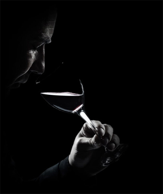 mysterious man drinking from wine glass